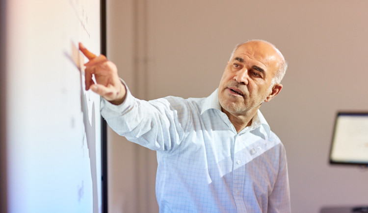 A man pointing at a whiteboard